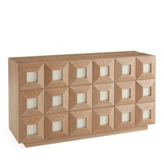 a large wooden cabinet with many squares on the front and sides, all in white glass inserts