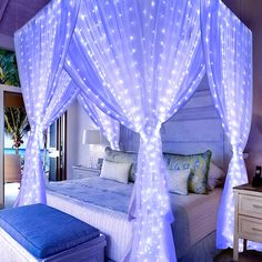 a bed with white lights on it and a blue bench in front of the bed