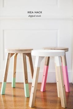 two wooden stools sitting on top of a hard wood floor next to each other