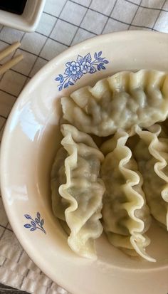 some dumplings are sitting in a bowl on a table