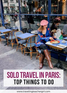 a woman sitting at a table in front of a window with the words solo travel in paris top things to do