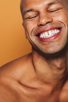 a man smiling with his eyes closed by an orange background for stockstation photoshop