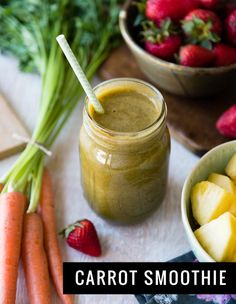 there is a bowl of fruit and vegetables next to a mason jar with a straw