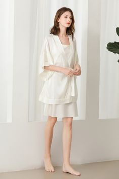 Fabric: 92% 19 Momme mulberry silk 8% Spandex Color: White Care: Hand wash or dry clean Silk robe dressing gown. Dolman sleeves. Shawl collar. Dropped shoulders. Open front. Fastens with a matching belt. Closing edge. Unlined. This wrap is designed with kimono proportions, but with a more modern short length. Elegant V-neck Loungewear Sets, Silk V-neck Kimono For Daywear, Satin V-neck Robe For Daywear, Elegant Spring Sleepwear With Kimono Sleeves, Elegant Sleepwear With Kimono Sleeves For Spring, Elegant Spring Wrap Sleepwear, Summer V-neck Night Robe, Summer Silk Robe For Sleep, Elegant Solid Color Summer Sleepwear