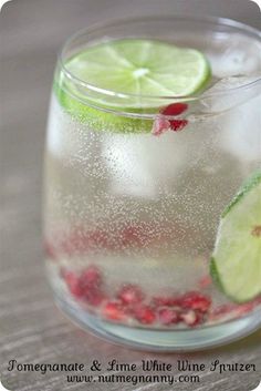 a pitcher filled with liquid and lime slices