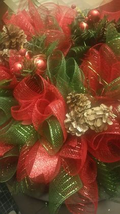 red and green christmas wreath with pine cones