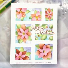 a close up of a christmas card with watercolor flowers on it and the words merry christmas written in cursive writing