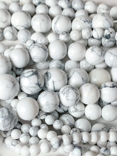 white and black marble beads are stacked together