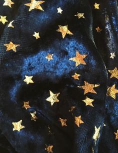 the fabric has gold stars on it and is dark blue with gold foiled edges