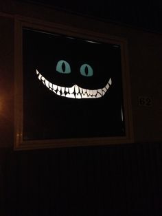 an image of a scary face projected in the window at night with light up eyes