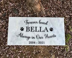 a memorial stone with the words, forever loved bella always in our hearts on it