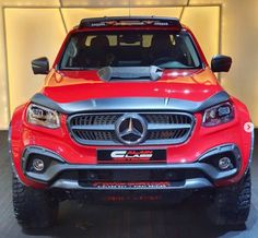 the front end of a red mercedes truck