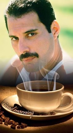 a man with a cup of coffee in front of his face and the caption's above it