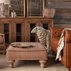 a living room filled with furniture and a sheep statue