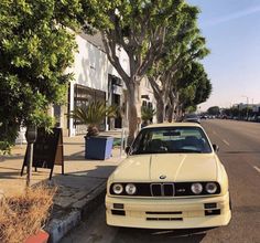 a white car parked on the side of a street