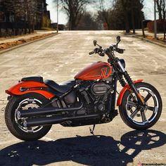 an orange motorcycle is parked on the street