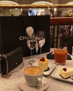 a table topped with desserts and wine glasses