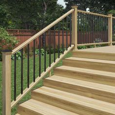 a wooden deck with wrought iron railing and hand rail