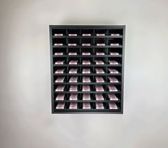 a black shelf filled with lots of pink packets