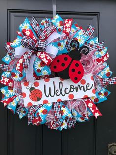 a ladybug wreath with the words welcome on it