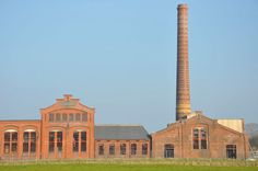 an old brick building with a tall chimney