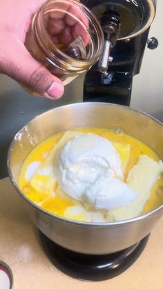 a person is pouring something into a bowl