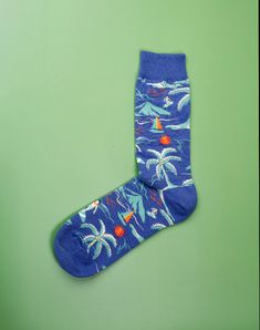 Providing the same feel of day relaxing or soaking up sun rays at the beach, these Beach Day Crew Socks serve as an ideal choice of footwear for any casual or vacation outing. The unique and vibrant pattern, depicting beach scenes such as waves, surfing, an umbrella and the sun, completes the look and makes a perfect casual sock for any beach our outdoor enthusiast. We all wish we could be at the beach at all times and these blue crew socks for men are the next best thing! Take your feet on a va Casual Multicolor Summer Socks, Casual Multicolor Socks For Summer, Green Cotton Summer Socks, Fun Multicolor Summer Socks, Green Summer Socks, Casual Cotton Summer Socks, Blue Cotton Socks For Summer, Casual Blue Outdoor Socks, Casual Blue Socks For Summer