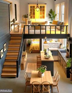 an open floor plan with stairs leading up to the loft bedroom and living room area