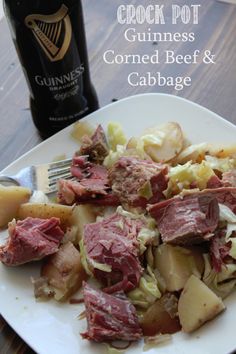 a white plate topped with corned beef and potatoes next to a bottle of guinness