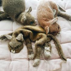 three stuffed animals laying on top of a bed