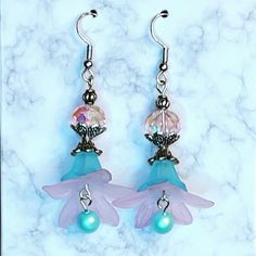 These pink and blue lucite and crystal bead earrings are so darling! Topped with a pink rondelle crystal bead, layered blue and pink acrylic flowers and finished off with a metallic blue Pearl dangle.  We can make these in different colors, just message us! Crystal Bead Earrings, Handmade Earings, Flower Dangle Earrings, Diy Jewelry Unique, Dance Jewelry, Earring Ideas, Pink Acrylic, Artisan Earrings, Wire Work Jewelry