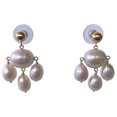 Gorgeous pair of chandelier handmade earrings by Marina J. This lovely pair feature high luster white Pearls that display beautiful hues of different colors when hit with light. A large Baroque Oval Pearl hangs in the middle, from which three TearDrop Pearls hang. A big bold solid 14k Yellow Gold Ball Stud sits perfectly on the ear and perfectly matches the gold wiring. Made will all 14k Yellow Gold wiring this pair measure a total of 1.5 inches long. ** Made in Los Angeles by Marina J. 2022 ** Pearl Chandelier Earrings, Pearl Chandelier, Gold For Sale, Gold Wire, Chandelier Earrings, Jewelry Earrings Studs, Handmade Earrings, Pearl White, Different Colors