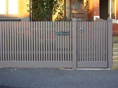 a gate with a sign on it in front of a house