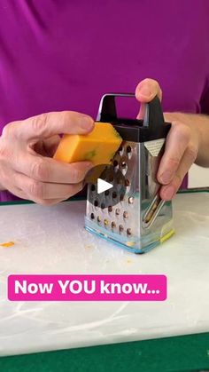 a person cutting cheese with a grater on top of a white board that says now you know