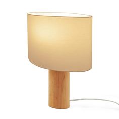 a wooden table lamp with a white shade on it's base and a cord attached to the light