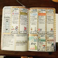 an open planner book sitting on top of a wooden table