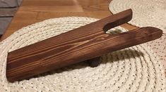 a wooden object sitting on top of a white rug