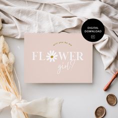 a pink flower girl card next to some coins