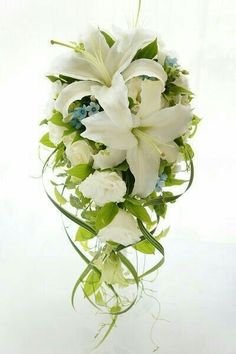 a bouquet of white and blue flowers in a vase