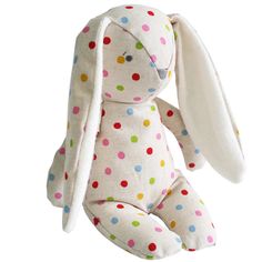 a white stuffed animal with multicolored polka dots