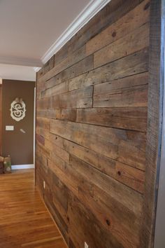 an empty room with wood paneling on the walls