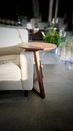 a white couch sitting next to a wooden table