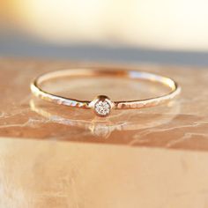 a diamond ring sitting on top of a table