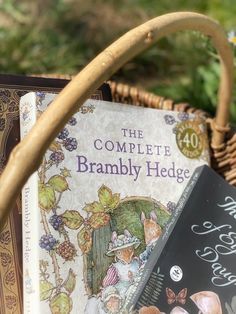 the complete brambly hedge book in a wicker basket next to other children's books