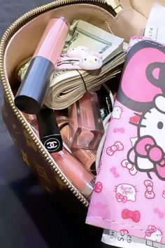 a hello kitty purse filled with makeup and other items