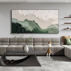 a living room with a couch, coffee table and painting on the wall above it