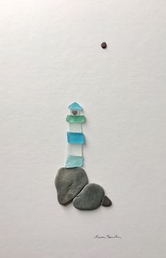 a piece of artwork made out of rocks and paper