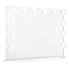 an illuminated vanity mirror with multiple bulbs on the top and bottom edge, in front of a white background