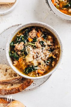 two bowls filled with soup and bread on top of a white countertop next to each other