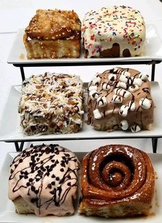 four tiered trays holding different types of donuts